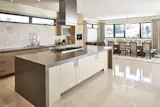 Throughout the house, the reflection of polished tile floors add to its bright, airy feel.