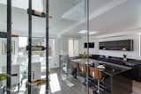 Chef's kitchen features luxurious amenities including a 10ft custom absolute black waterfall island,
