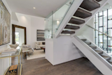Custom glass stairs leading to second floor bedrooms. 