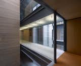 Hallway Stone, wood, glass parapets and steel plates, main materials used in the building   Photo 6 of 9 in Madroños 27 by Bueso-Inchausti & Rein Arquitectos