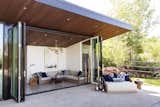 Doors, Exterior, Metal, and Folding Door Type "Everything is intended to blur the distinction between indoor and outdoor living," says Bellessa.   Photo 6 of 16 in This Can-Do Pool House Cleverly Goes From Private to Party Mode from Modern Mountain Pool House