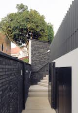 Garden walls, in black bricks, lead onto a flight of gentle steps.