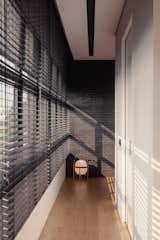 Hallway and Medium Hardwood Floor Black bricks flow into the interior and animated by light and shadow.  Photo 15 of 22 in Trio Stack (a.k.a Project #10) by Studio Wills + Architects