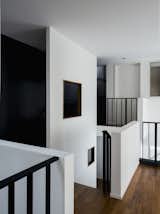 In the Family Area within the original house, one catches a glimpse of the Master Suite (within the new extension) and a new flight of stairs along the party wall.