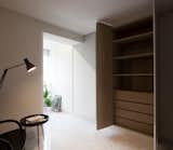 In the Master Bedroom, white and grey wardrobe doors hide extensive storage spaces in a warm hue.