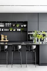 Kitchen, Colorful Cabinet, Open Cabinet, Track Lighting, Wall Oven, Cooktops, Metal Counter, Metal Cabinet, Concrete Floor, Microwave, and Metal Backsplashe The Kitchen  Photo 3 of 29 in C Apartment by Maya Sheinberger