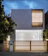 Street view and main entrance at twilight.