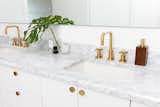 Master bathroom vanity with marble and brass Kohler fixtures