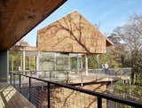 Exterior, Metal, Wood, Flat, Glass, House, and Gable View from outdoor porch by Low Design Office  Exterior Flat Wood Gable Metal Glass Photos from Guadalupe River House