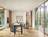 View of dining area and outdoor porch in the trees by Low Design Office
