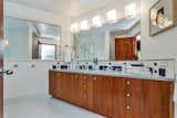 Double Sink and vertical Mahogany Cabinets in Children's Bath