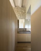 Bath Room, Light Hardwood Floor, Medium Hardwood Floor, Stone Counter, Stone Slab Wall, and Vessel Sink  Photos from Sant Martí House