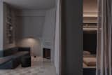 The living room has an original fireplace that has been partially painted in the same gray color as the dwelling.