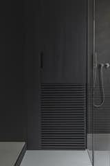 Detail of the bathroom in poplar wood stained in black.