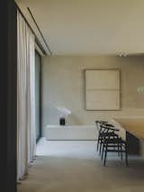 Taccia table lamp by Flos, CH24 chair by Carl Hansen & Son, work of art by Antonia Ferrer, and T TABLE by RI HOUSE.