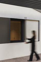 Detail of the sliding steel shutters, designed to seamlessly integrate into the façade while offering flexibility in controlling light and privacy. A dynamic architectural element that enhances the home’s minimalist aesthetic.