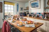 Feast-worthy, reclaimed breakfast bar in the full kitchen with a marsh & wind farm view. 