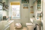 Nautical kitsch—carefully considered—and a soaker tub/shower in the family bath. 