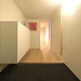 Hallway, Light Hardwood Floor, and Concrete Floor entrance makes you feel in a cave.  Photos from Case Study House #58