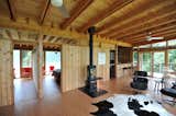 The Great Room center wall features Western Red Cedar siding and a Norwegian wood stove.