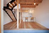Living Room, End Tables, Light Hardwood Floor, Chair, Standard Layout Fireplace, Ceiling Lighting, Gas Burning Fireplace, Concrete Floor, and Accent Lighting  Photo 1 of 19 in A-small-house-in-higashimurayama by keigo iiduka