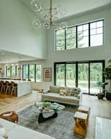 Living Room, Sofa, Lamps, Console Tables, Light Hardwood Floor, Stools, Ottomans, Standard Layout Fireplace, Coffee Tables, End Tables, Ceiling Lighting, Accent Lighting, Table Lighting, and Gas Burning Fireplace Dorchester Interior Great Room/Kitchen  Photo 10 of 40 in The Dorchester Project by  Paul + Jo Studio by Barbara Koch