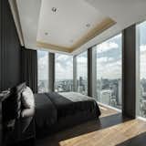 Bedroom, Ceiling Lighting, Recessed Lighting, Bed, and Travertine Floor View from Master Bedroom, 270degree view of Bangkok skyline.   Photo 12 of 14 in The Ritz-Carlton Residences @Mahanakorn Building by Pitch Nimchinda