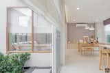 Dining Room, Stools, Table, Porcelain Tile Floor, Bench, Pendant Lighting, and Recessed Lighting How to take nature benefit when we’re living inside  Photo 5 of 20 in Khun Kwin's Residence by Pitch Nimchinda