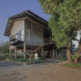 Exterior, House Building Type, Metal Roof Material, Wood Siding Material, Concrete Siding Material, Metal Siding Material, and Gable RoofLine The climate responsive house that user can stay all day without A/C or stay dry and comfortable when rainy season.  Photo 2 of 19 in Baan Lek Villa by Pitch Nimchinda