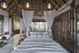Bedroom, Ceiling Lighting, Cement Tile Floor, and Bed Interior Upper Level View of Bed with the curtains drawn  Photo 4 of 14 in Tala Treesort by Architecture BRIO