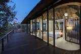 Evening view of upper deck with curved glass facade