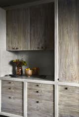 The country style kitchen is finished in white pigmented polished cement