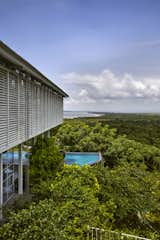 Exterior, Farmhouse Building Type, Hipped RoofLine, Metal Roof Material, House Building Type, and Wood Siding Material Breathtaking panoramic views from the lush green roof gardens of the villa  Photo 11 of 21 in The Ray, a plantation retreat by Architecture BRIO