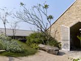 Exterior, Shed RoofLine, House Building Type, Stone Siding Material, Hipped RoofLine, Metal Roof Material, and Farmhouse Building Type  Photo 13 of 21 in The Ray, a plantation retreat by Architecture BRIO