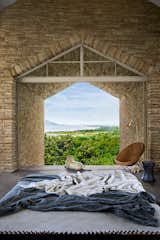 Bedroom, Concrete Floor, Floor Lighting, Chair, and Bed The vantage point  Photo 18 of 21 in The Ray, a plantation retreat by Architecture BRIO