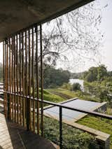 Verandah overlooking a river with infinity swimming pool
