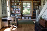 Office, Lamps, Library Room Type, Chair, Light Hardwood Floor, Study Room Type, Desk, Bookcase, and Shelves Sunlit library and office space. A mix of modern and antique aesthetics bring the rustic feel together with the modern times. The library books range from fiction to encyclopedias and just about any cookbook you could imagine. This desk space offers a work environment without being at the office.  Photo 4 of 20 in Modern Farmhouse by Hygge Stay