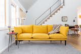 Floyd Detroit Sofa in Saffron makes a bright accent piece in the naturally lit great room.