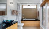 Bath Room, Wall Lighting, Ceiling Lighting, Two Piece Toilet, Undermount Tub, Subway Tile Wall, Vessel Sink, Open Shower, Granite Counter, and Porcelain Tile Floor Bathroom  Photo 8 of 13 in The GenY House by Robert Matthews
