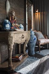 Chinese porcelain lamp, wood carved furniture and handwoven rugs creates a charming feelings