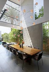 The dining room is outdoors, but the two story walls and slatted screen creates protection from the elements