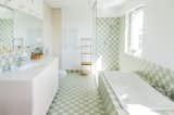 The pastel tiles used by Atelier Starzak Strebicki bring a calming mood to the washroom.
