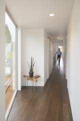 The 2nd floor corridor creates a light-filled axial connection to all 4 bedrooms and their amenities.