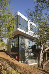 Exterior, Flat, Tile, Wood, Metal, House, Concrete, and Prefab The house wraps itself around the historic tree while allowing the natural landscape to do the same around itself.  Exterior Prefab Tile Metal Concrete Wood House Photos from Farwell