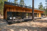 The standing seam metal roof wraps the house crating simple shelter.