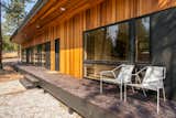 A broad deck provides ample space to relax while also doubling as an entrance porch.