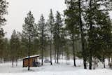 Nestled amongst the ponderosa pines, the slender volume marks is presence.