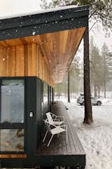 The long deck is covered by generous roof overhangs that create an intimate space.