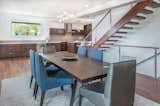 The open plan extends towards the kitchen creating a dialogue between spaces. The kitchen wraps itself around walls and becomes a bar for the dining area.