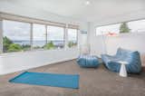 Large windows capture the view and provide abundant light into a study-meditation space.
